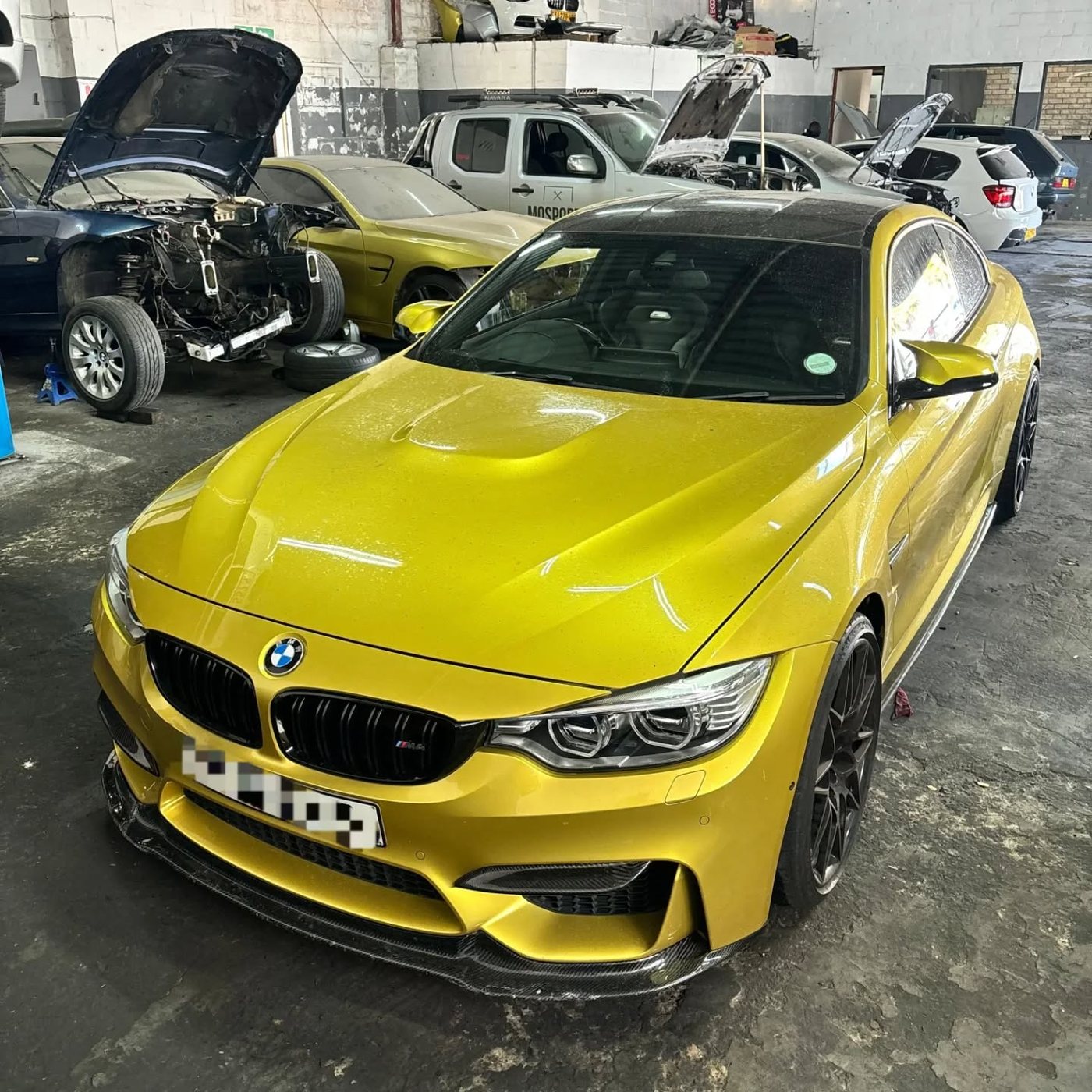 Yellow BMW in the workshop