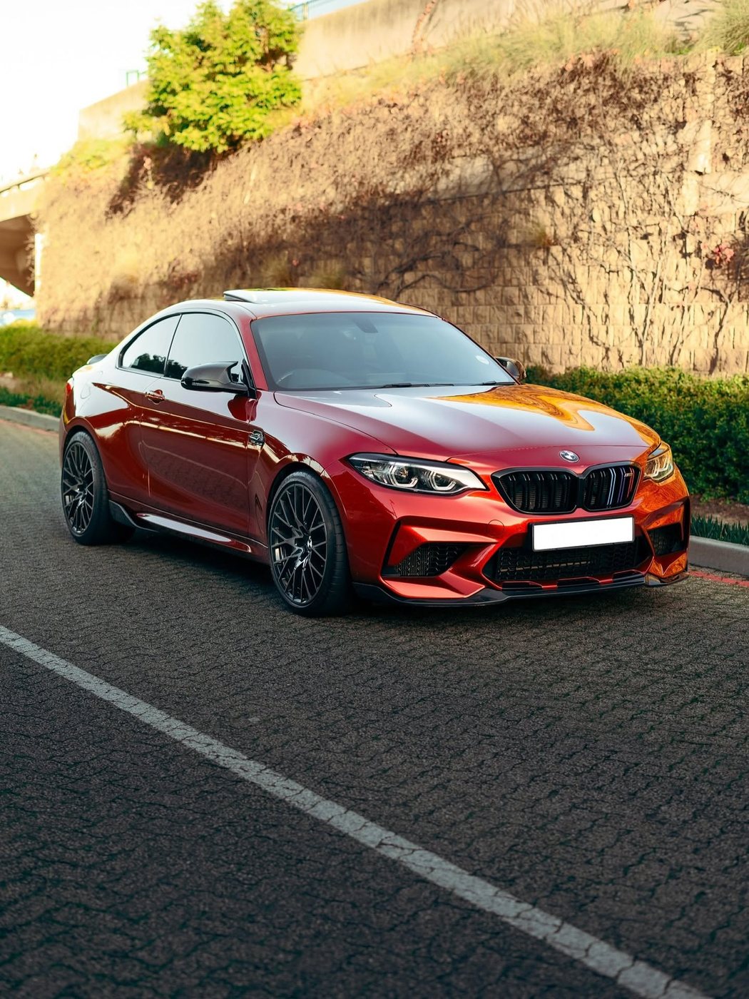 Red performance BMW on the road